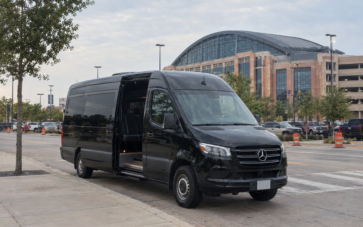 Black Sprinter van with its side door open near Globe Life Field in Arlington