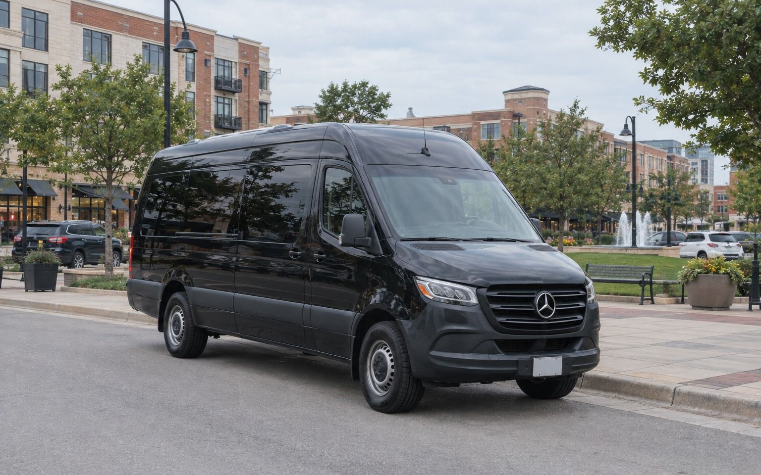 Black Mercedes-Benz Sprinter van parked on a shop-lined street in Frisco